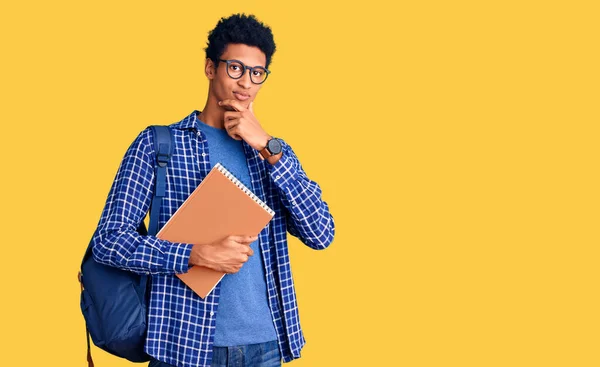 Young African American Man Wearing Student Backpack Holding Book Looking — Stock Photo, Image