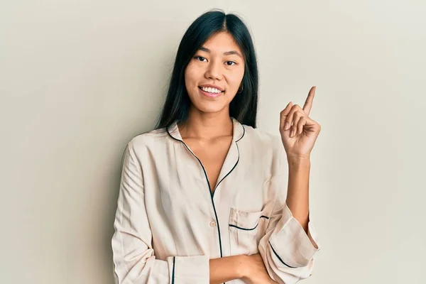 Young Chinese Woman Wearing Pajama Smiling Happy Pointing Hand Finger — Stock Photo, Image