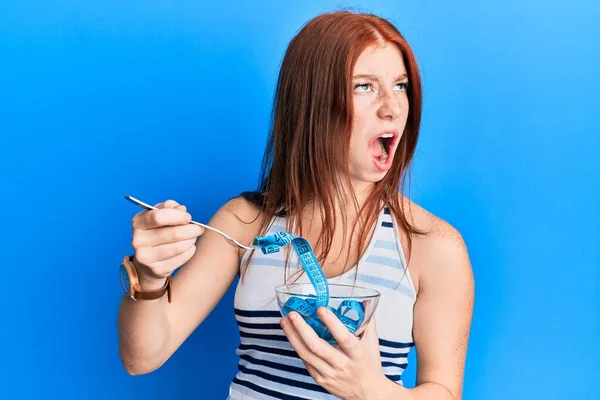 Young Red Head Girl Eating Measure Meter Doing Diet Weight —  Fotos de Stock