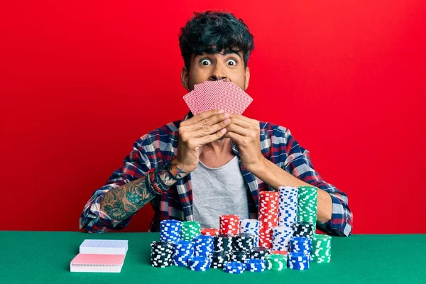 Young Hispanic Man Playing Gambling Poker Covering Face Cards Celebrating — Stock Photo, Image