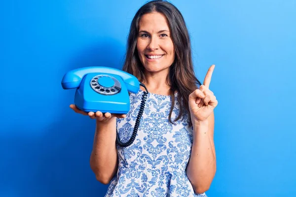 Jong Mooi Brunette Vrouw Holding Vintage Telefoon Geïsoleerde Blauw Achtergrond — Stockfoto