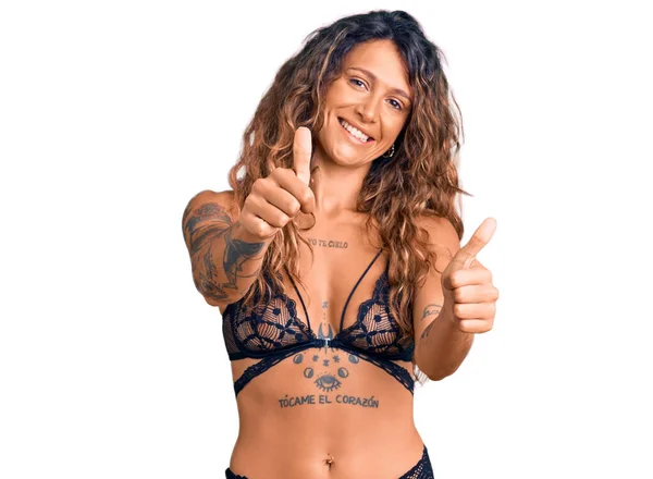 Young Hispanic Woman Tattoo Wearing Lingerie Approving Doing Positive Gesture — Stock Photo, Image