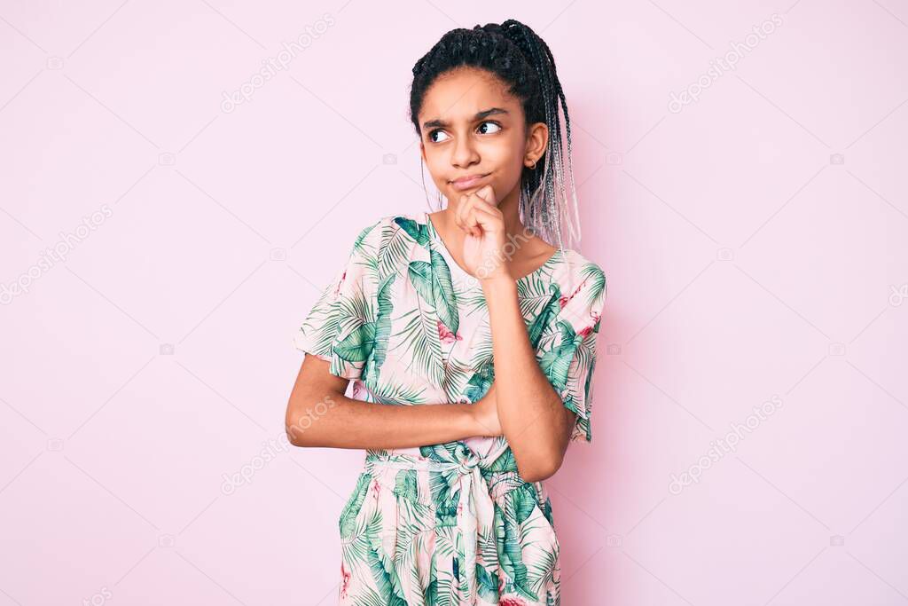 Young african american girl child with braids wearing summer style serious face thinking about question with hand on chin, thoughtful about confusing idea 