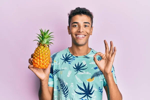 Mladý Pohledný Africký Američan Drží Ananas Dělá Znamení Prsty Usmívá — Stock fotografie