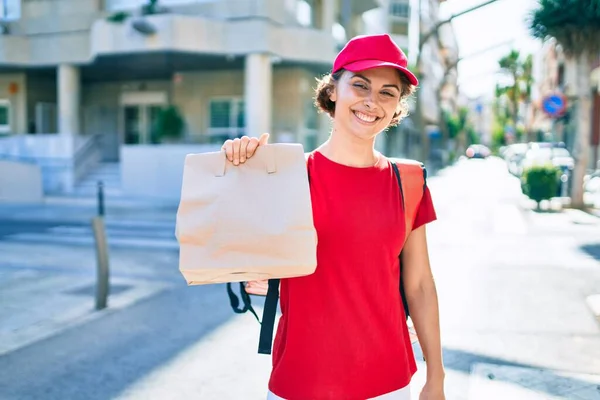 Delivery business worker woman wearing uniform and delivery bag smiling happy