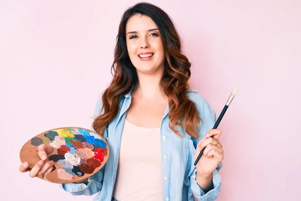 Young Beautiful Brunette Woman Holding Paintbrush Palette Looking Positive Happy — Stock Photo, Image