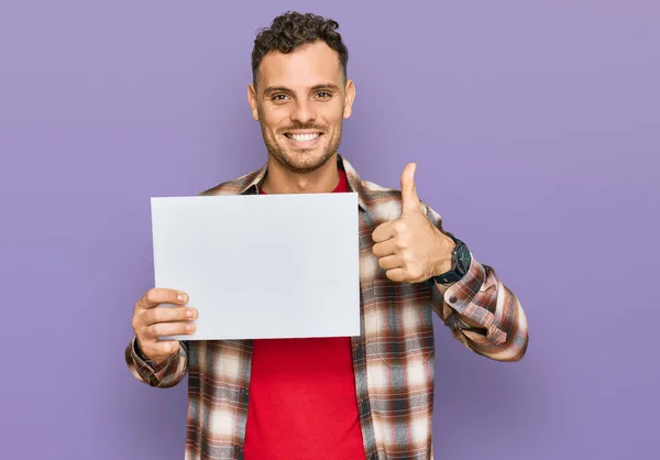 Young Hispanic Man Holding Blank Empty Banner Smiling Happy Positive — Stock Photo, Image
