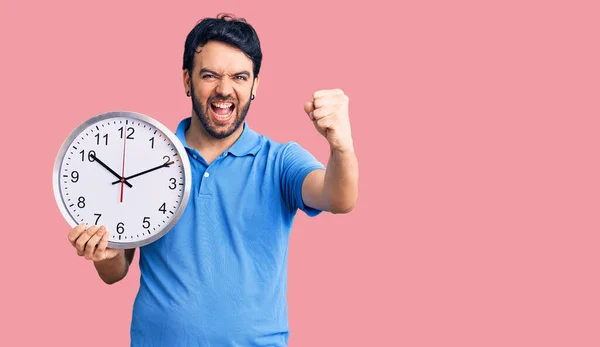 Young Hispanic Man Holding Big Clock Annoyed Frustrated Shouting Anger — Stock Photo, Image