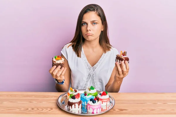 Young Caucasian Woman Holding Cake Slices Depressed Worry Distress Crying — Stock Photo, Image