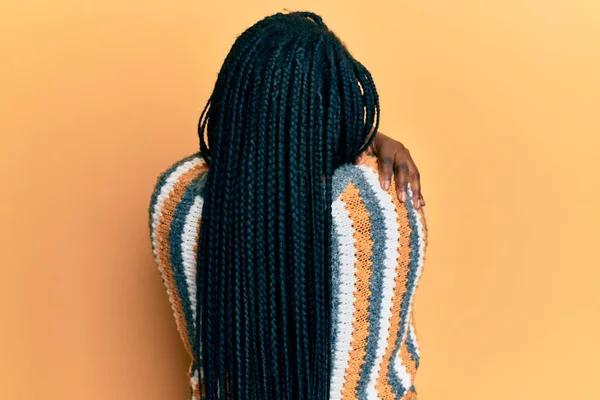 Young Black Woman Braids Wearing Casual Winter Sweater Hugging Oneself — Stock Photo, Image