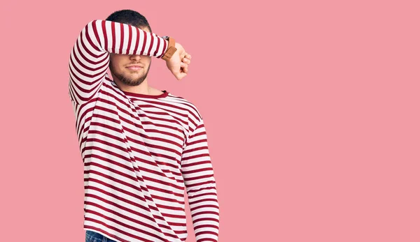 Young Handsome Man Wearing Striped Sweater Covering Eyes Arm Looking — Stock Photo, Image
