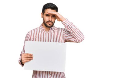 Elinde boş pankart tutan genç İspanyol adam elleri kafasında, şaşırmış ve kızgın yüzüyle stresli ve hayal kırıklığına uğramış. 