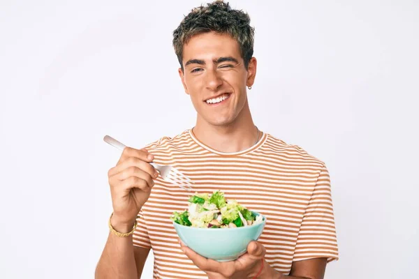 Young Handsome Man Eating Salad Winking Looking Camera Sexy Expression — Stock Photo, Image