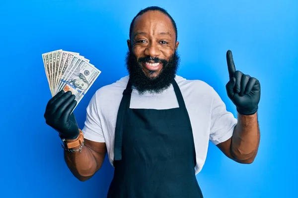 Young African American Man Wearing Professional Apron Holding Usa Dollars — Stock Photo, Image