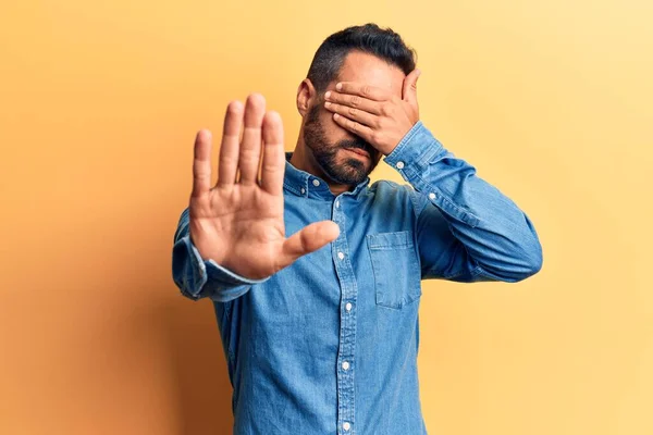 Young Hispanic Man Wearing Casual Clothes Covering Eyes Hands Doing — Stock Photo, Image