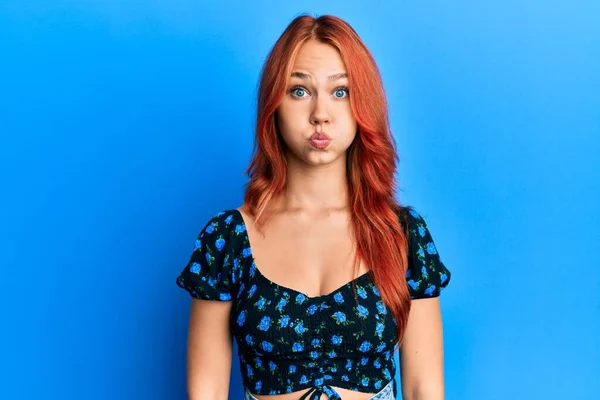 Young Beautiful Redhead Woman Wearing Casual Clothes Blue Background Puffing — Stock Photo, Image