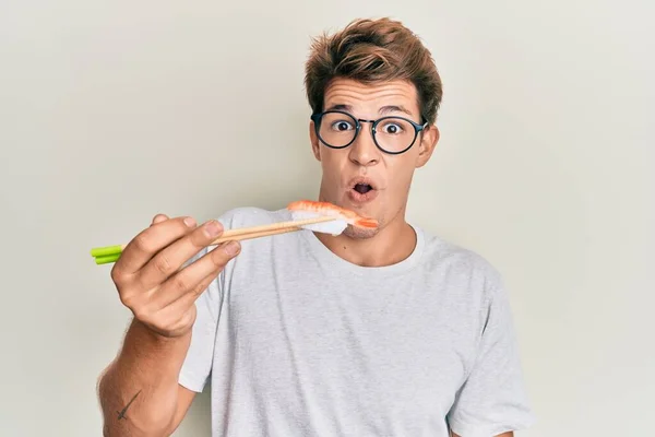 Bonito Homem Caucasiano Comendo Sushi Camarão Usando Pauzinhos Assustados Espantados — Fotografia de Stock