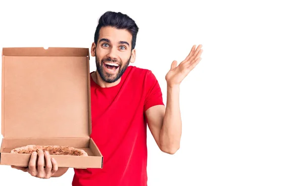 Young Handsome Man Beard Holding Delivery Cardoboard Italian Pizza Celebrating — Stock Photo, Image