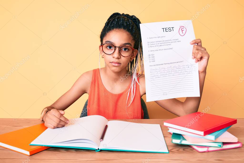 Young african american girl child with braids showing failed exam thinking attitude and sober expression looking self confident 