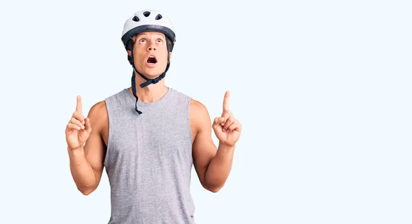 Young Handsome Man Wearing Bike Helmet Amazed Surprised Looking Pointing — Stock Photo, Image