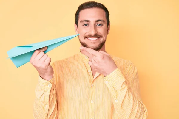 Young Handsome Man Holding Paper Airplane Smiling Happy Pointing Hand — ストック写真