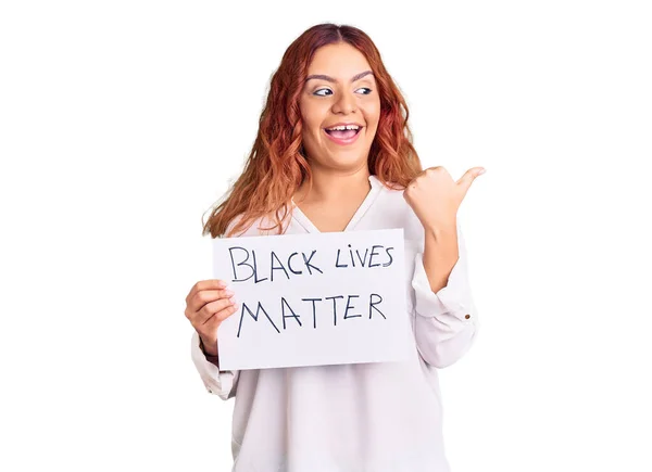 Young Latin Woman Holding Black Lives Matter Banner Pointing Thumb — 스톡 사진