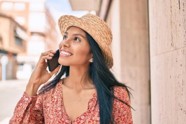 Genç Afro-Amerikan turist kadın tatilde. Şehirdeki akıllı telefondan konuşuyor..