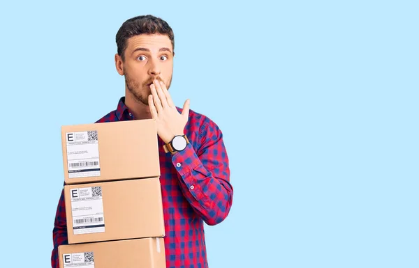 Handsome Young Man Bear Holding Delivery Packages Covering Mouth Hand — Stock Photo, Image