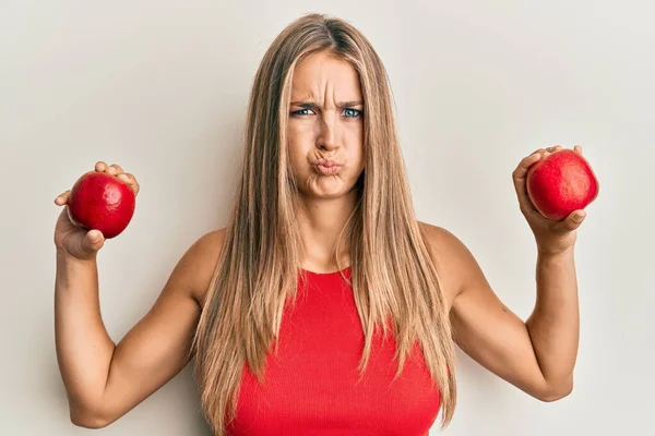 Young Blonde Woman Holding Red Apples Puffing Cheeks Funny Face — Foto Stock