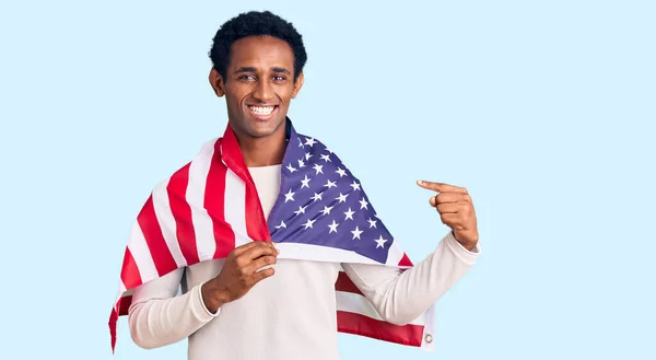 African Handsome Man Holding United States Flag Smiling Happy Pointing Royalty Free Stock Photos