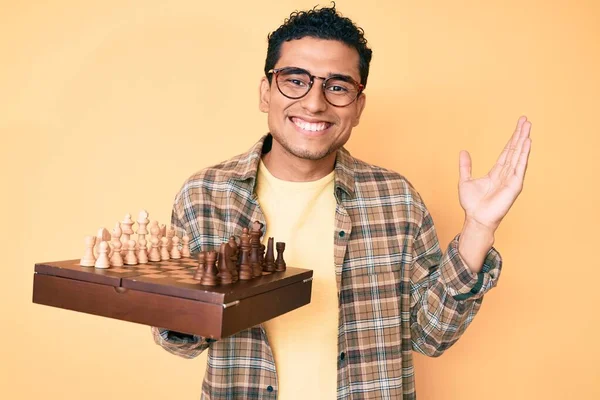 Young Handsome Hispanic Man Holding Chess Board Wearing Glasses Celebrating — Stock Photo, Image