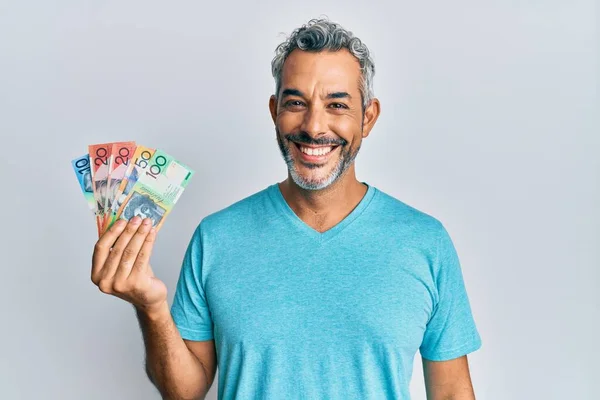 Middle Age Grey Haired Man Holding Australian Dollars Looking Positive — Stock fotografie