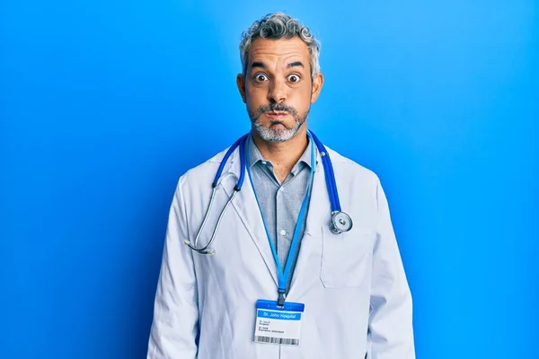 Middle Age Grey Haired Man Wearing Doctor Uniform Stethoscope Puffing — Stok fotoğraf