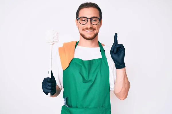 Young Handsome Man Wearing Apron Holding Toilet Brush Surprised Idea — Stock fotografie