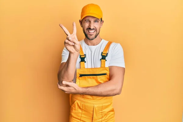 Young Handsome Man Wearing Handyman Uniform Yellow Background Smiling Happy — 스톡 사진