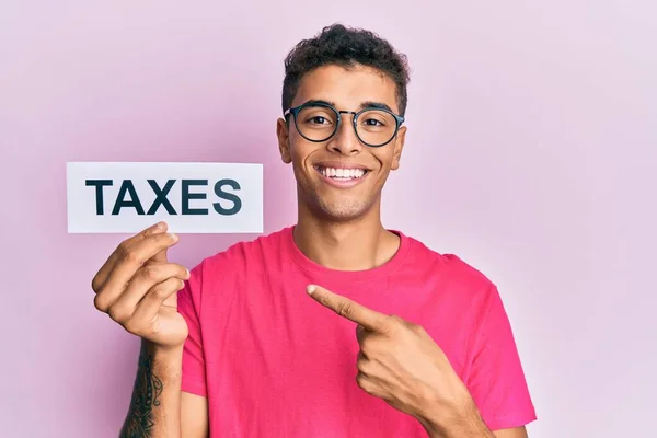 Young Handsome African American Man Holding Taxes Word Smiling Happy — Stock Photo, Image