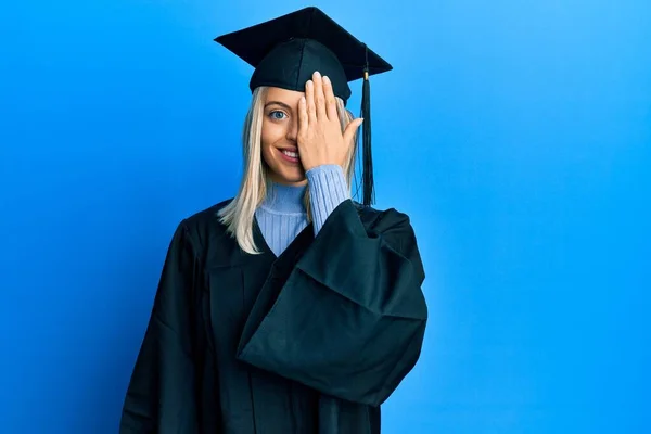 Schöne Blonde Frau Mit Abschlussmütze Und Zeremonienmantel Die Ein Auge — Stockfoto