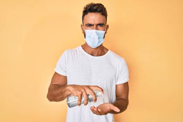 Jonge Spaanse Man Draagt Een Medisch Masker Houdt Hand Reiniger — Stockfoto
