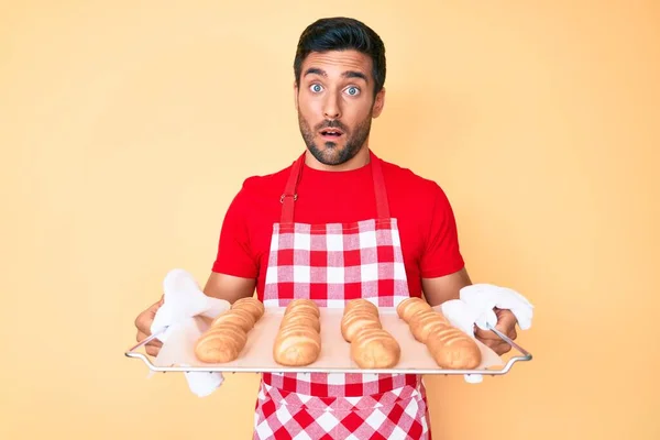 Young Hispanic Man Wearing Baker Apron Holding Homemade Bread Shock — 스톡 사진