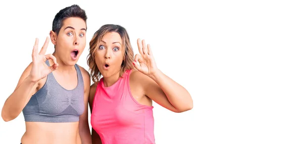 Couple Women Wearing Sportswear Looking Surprised Shocked Doing Approval Symbol — Stock Photo, Image