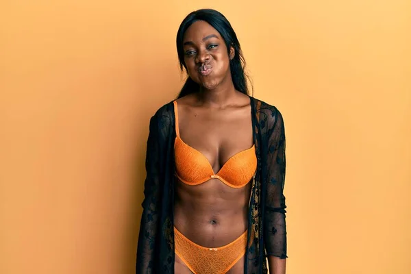 Young African American Woman Wearing Lingerie Puffing Cheeks Funny Face — Stock Photo, Image