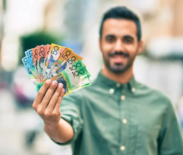 Jonge Spaanse Man Glimlacht Gelukkig Terwijl Hij Australische Dollars Vasthoudt — Stockfoto