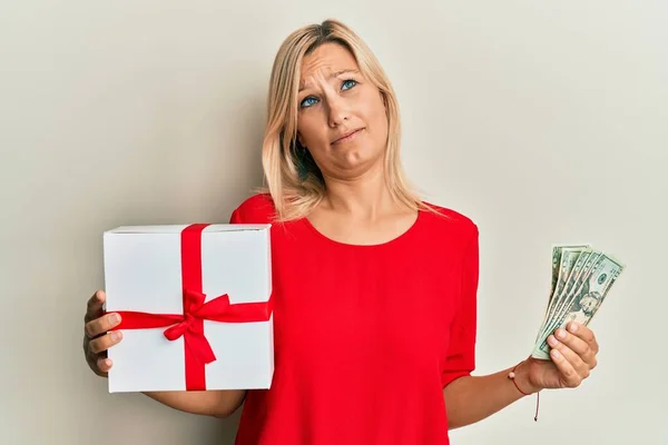 Middle Age Caucasian Woman Holding Gift Dollars Shock Face Looking — Stock Photo, Image