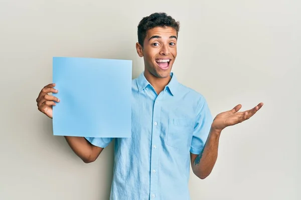 Young Handsome African American Man Holding Blue Blank Empty Banner — Stock Photo, Image
