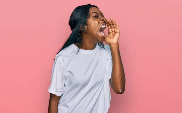 Mujer Afroamericana Joven Con Camiseta Blanca Casual Gritando Gritando Fuerte —  Fotos de Stock