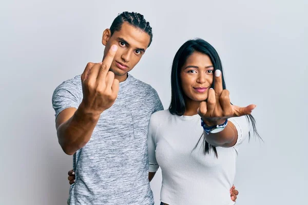 Young Latin Couple Wearing Casual Clothes Showing Middle Finger Impolite — Stockfoto