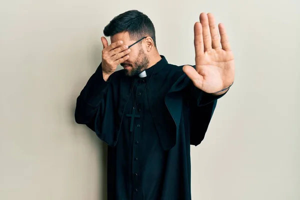 Joven Hombre Hispano Vistiendo Uniforme Sacerdote Pie Sobre Fondo Blanco —  Fotos de Stock