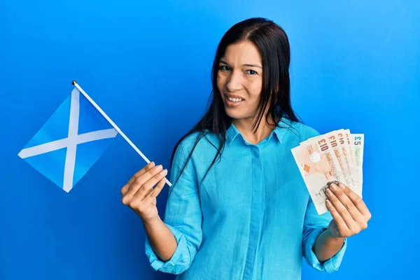 Молодая Латиноамериканка Шотландским Флагом Фунтами Банкнот Невежественное Запутанное Выражение Лица — стоковое фото