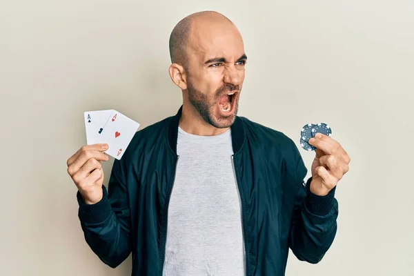 Young Hispanic Man Playing Poker Holding Casino Cards Chips Angry — Stock Photo, Image