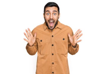 Sıradan kıyafetler giyen genç İspanyol adam çılgın ve başarıyı kollarını kaldırıp heyecanla haykırarak kutluyor. Kazanan konsept 